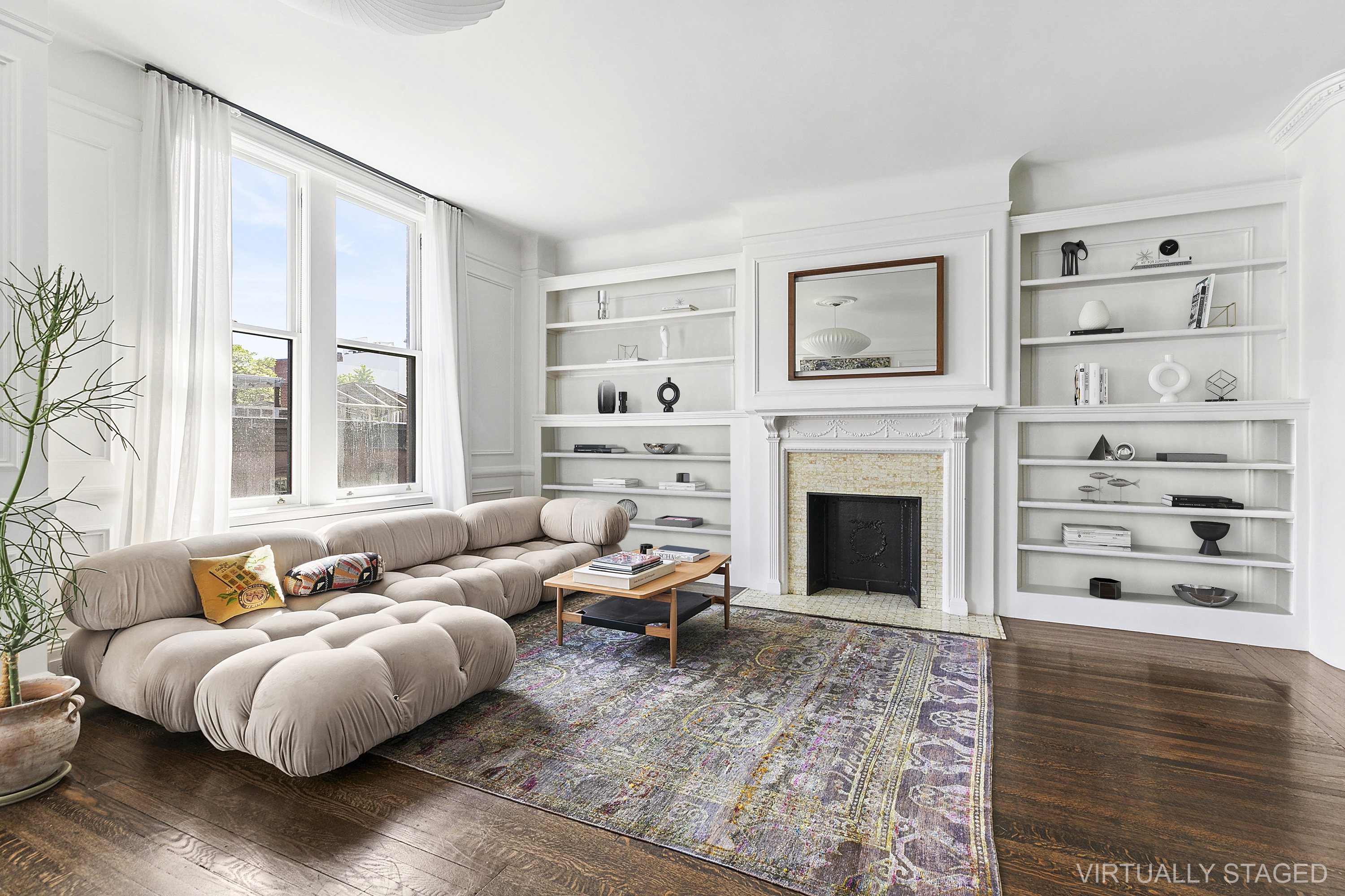 31 West 12th Street, Unit 5E Manhattan, NY 10011 - Photo 2 of 14 a living room with furniture fireplace and a large window
