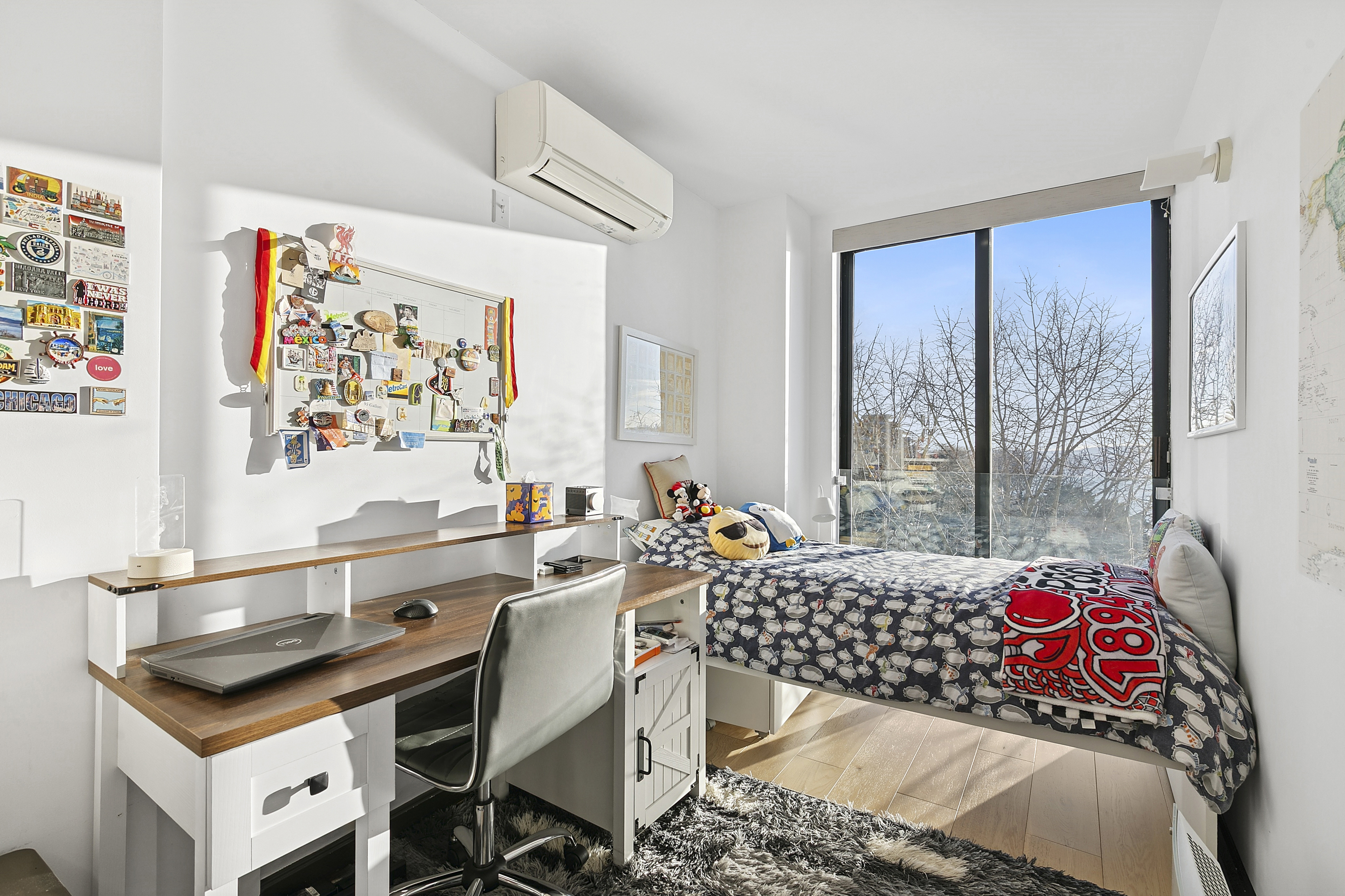 21 South End Avenue, Unit 402 Manhattan, NY 10280 - Photo 9 of 13 a bedroom with a bed and a table