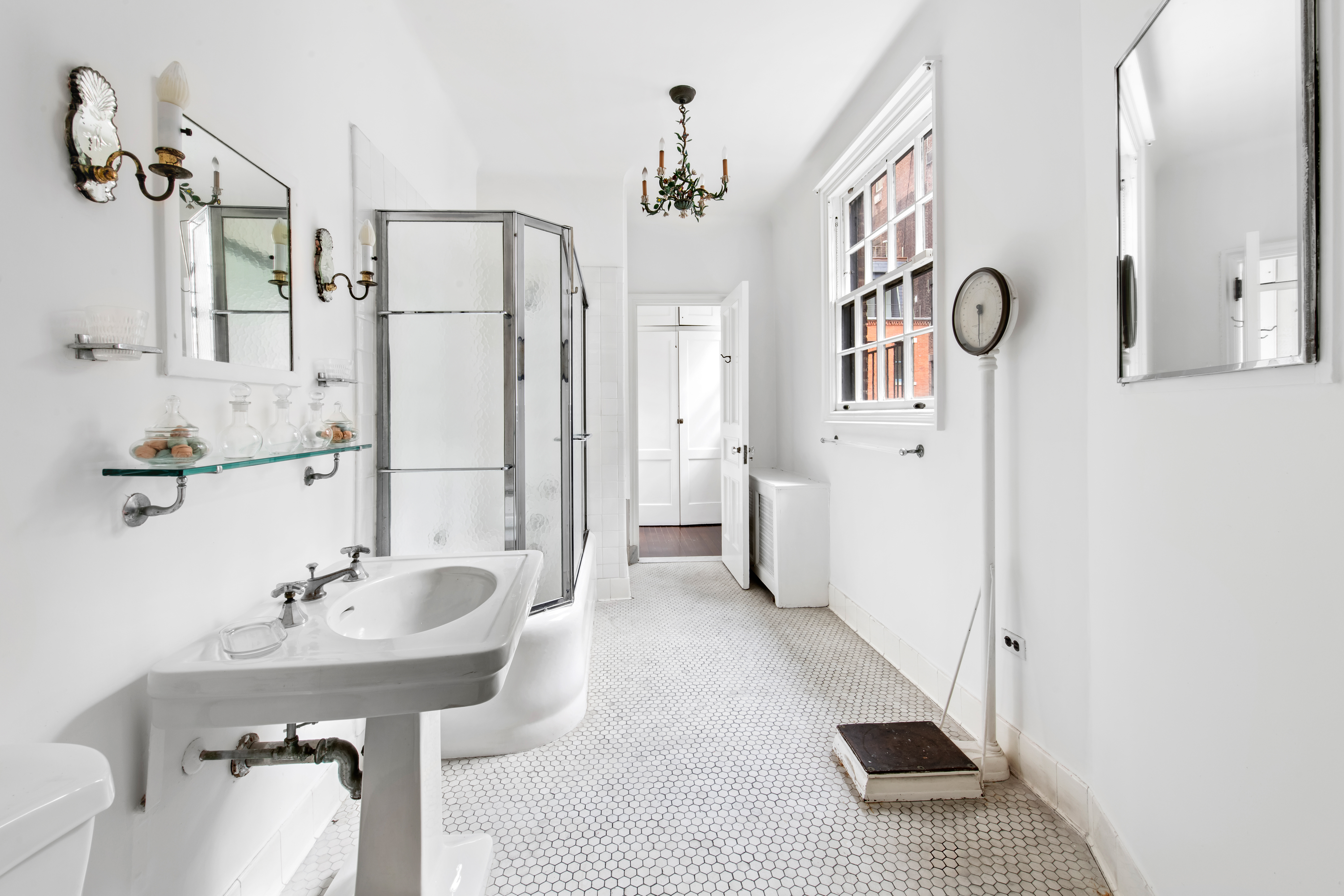 155 East 70th Street Manhattan, NY 10021 - Photo 20 of 27 a bathroom with a sink a mirror and a shower