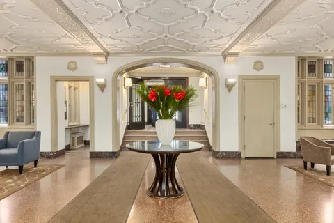 a lobby with furniture and wooden floor