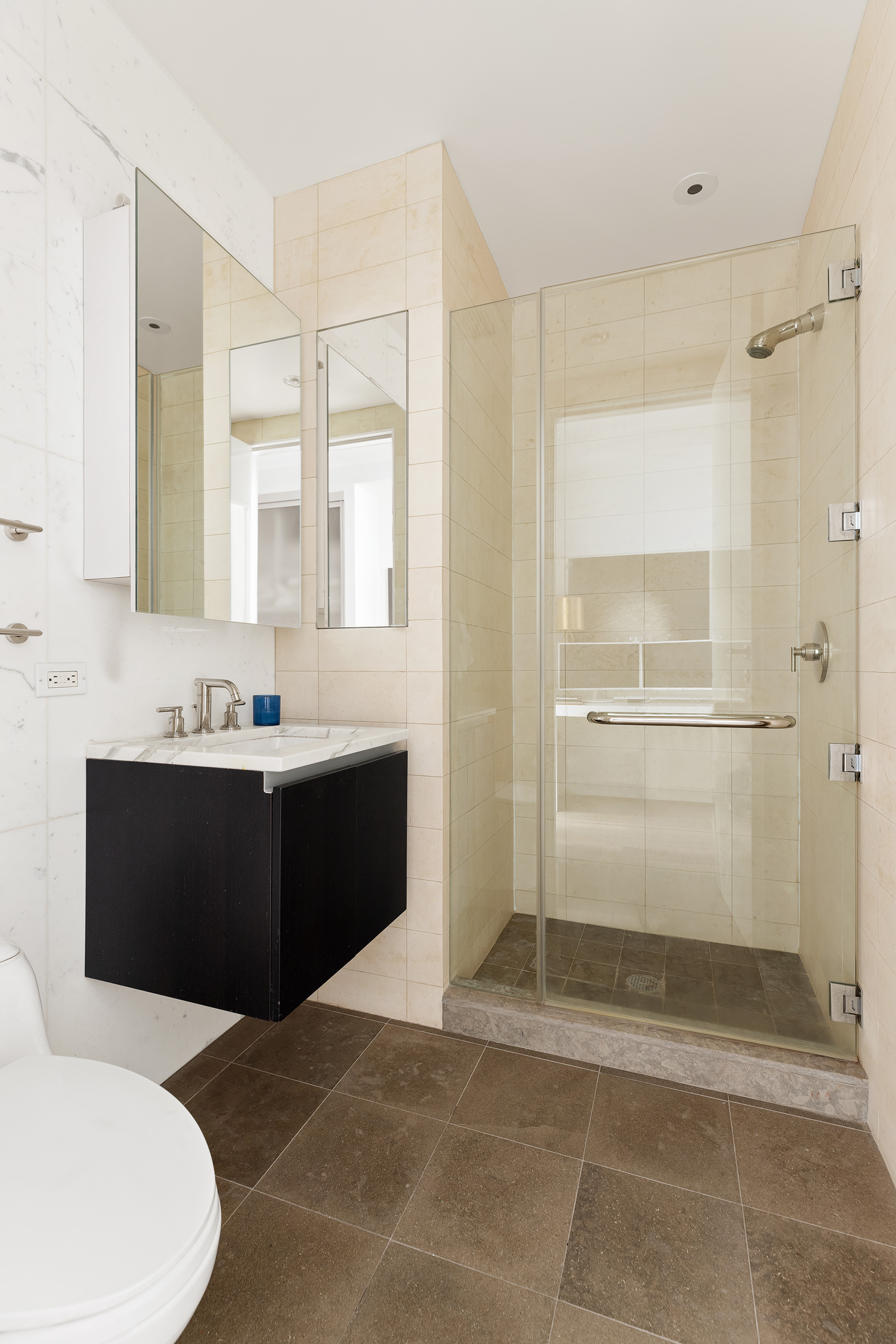 51 Walker Street, Unit 4B Manhattan, NY 10013 - Photo 8 of 13 a bathroom with a sink a toilet and shower