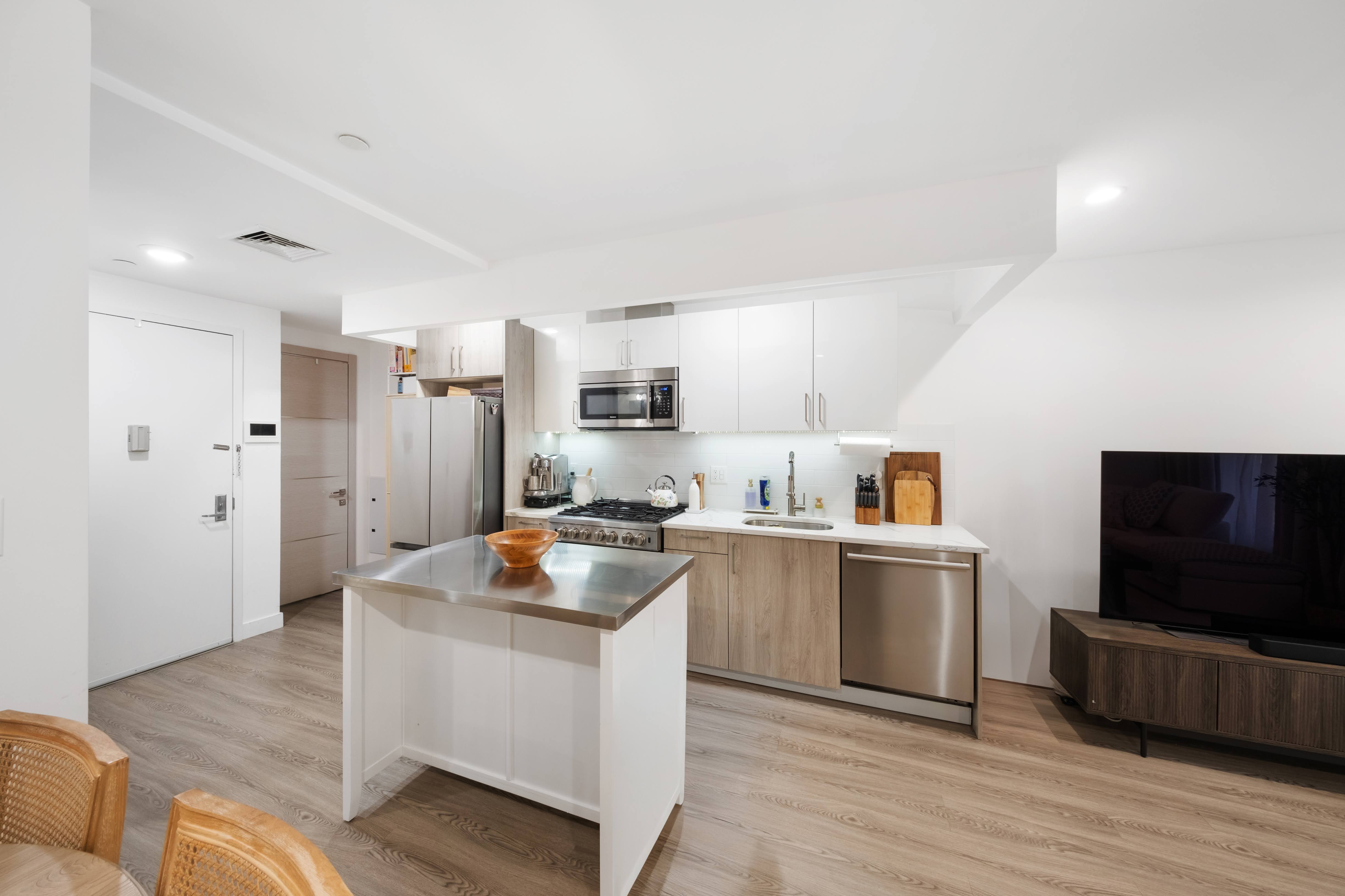 2025 Ocean Avenue, Unit 1B Brooklyn, NY 11230 - Photo 3 of 10 a kitchen with stainless steel appliances granite countertop a stove top oven a refrigerator a sink and dishwasher with wooden floor