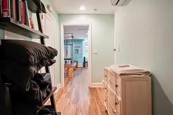 a view of walk in closet with clothes and shoes