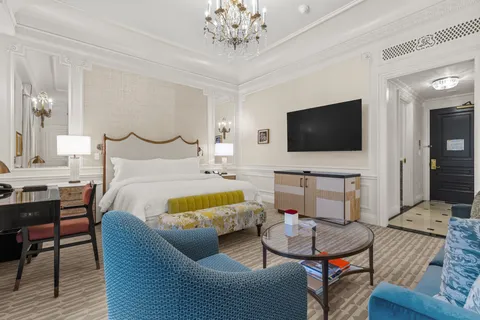 a bedroom with furniture and a flat screen tv