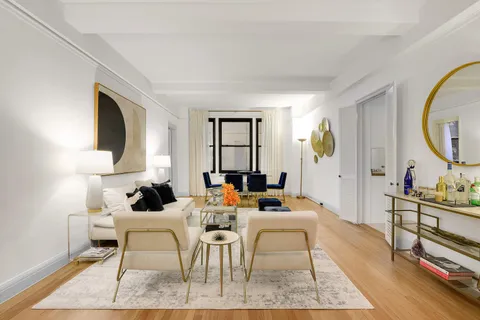 a living room with furniture a rug and a painting on the wall