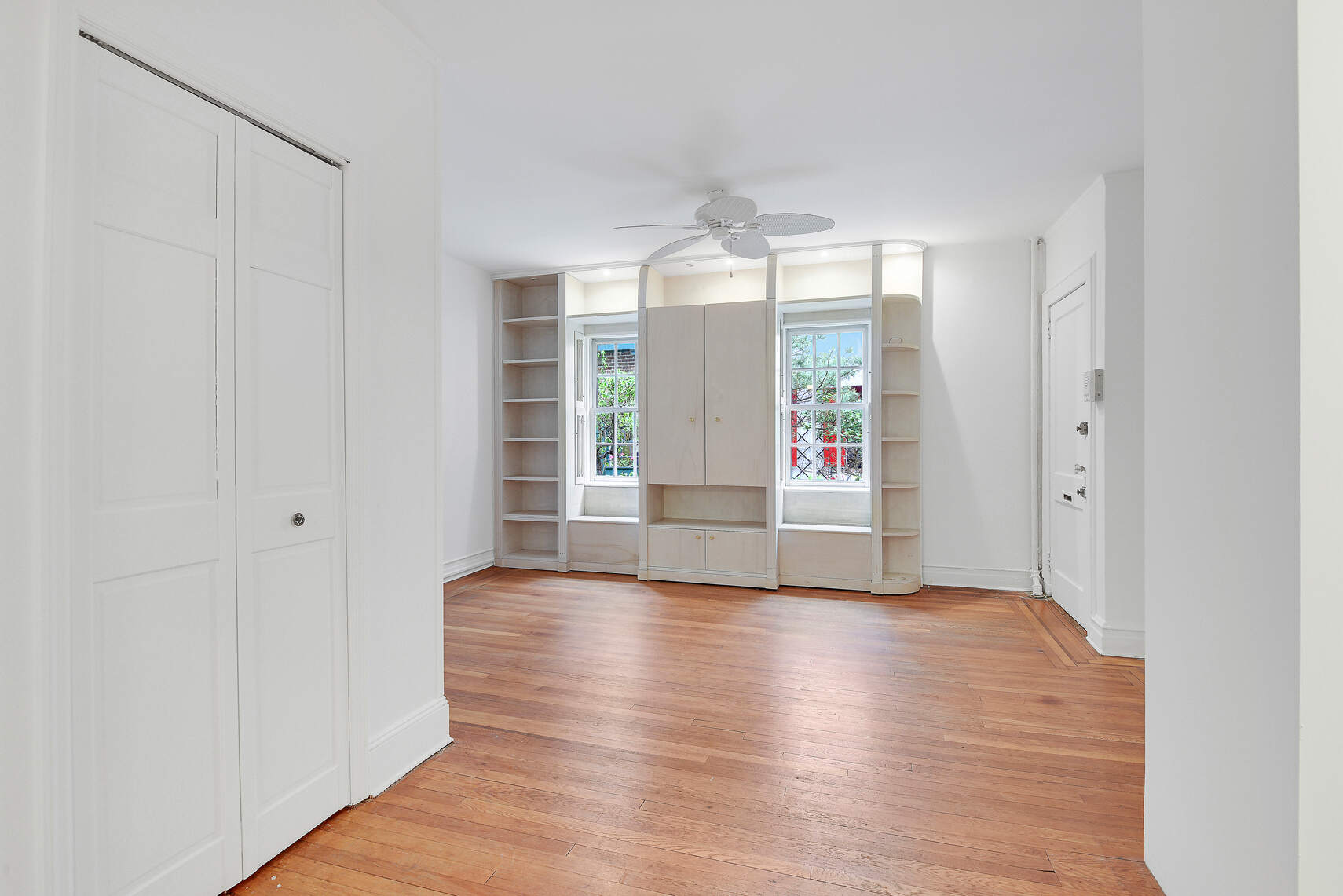 19 Pomander Walk, Unit 1 Manhattan, NY 10025 - Photo 4 of 10 a view of an empty room with window and wooden floor