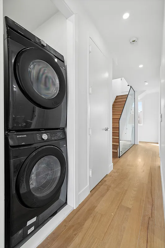 483 Hart Street, Unit PH Brooklyn, NY 11221 - Photo 13 of 17 a view of a hallway with washer and dryer