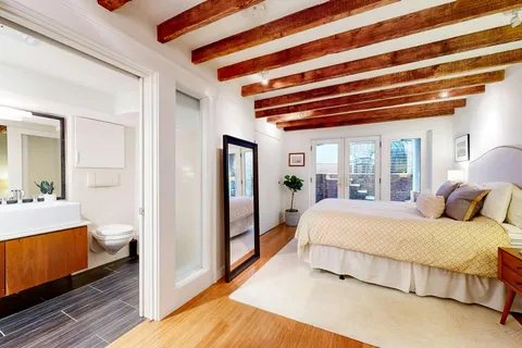 a bedroom with a bed and a mirror
