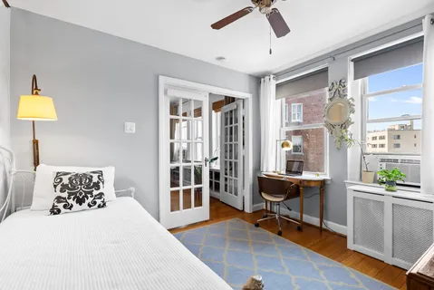 a bedroom with furniture and a window