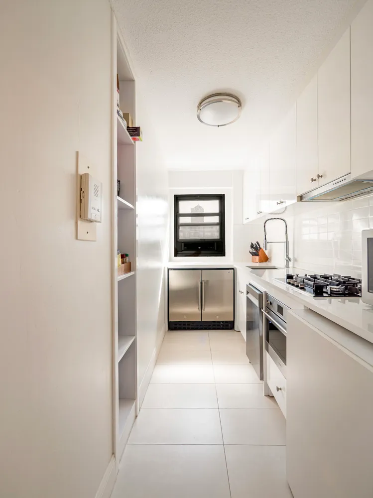 a kitchen with a stove a sink and a refrigerator