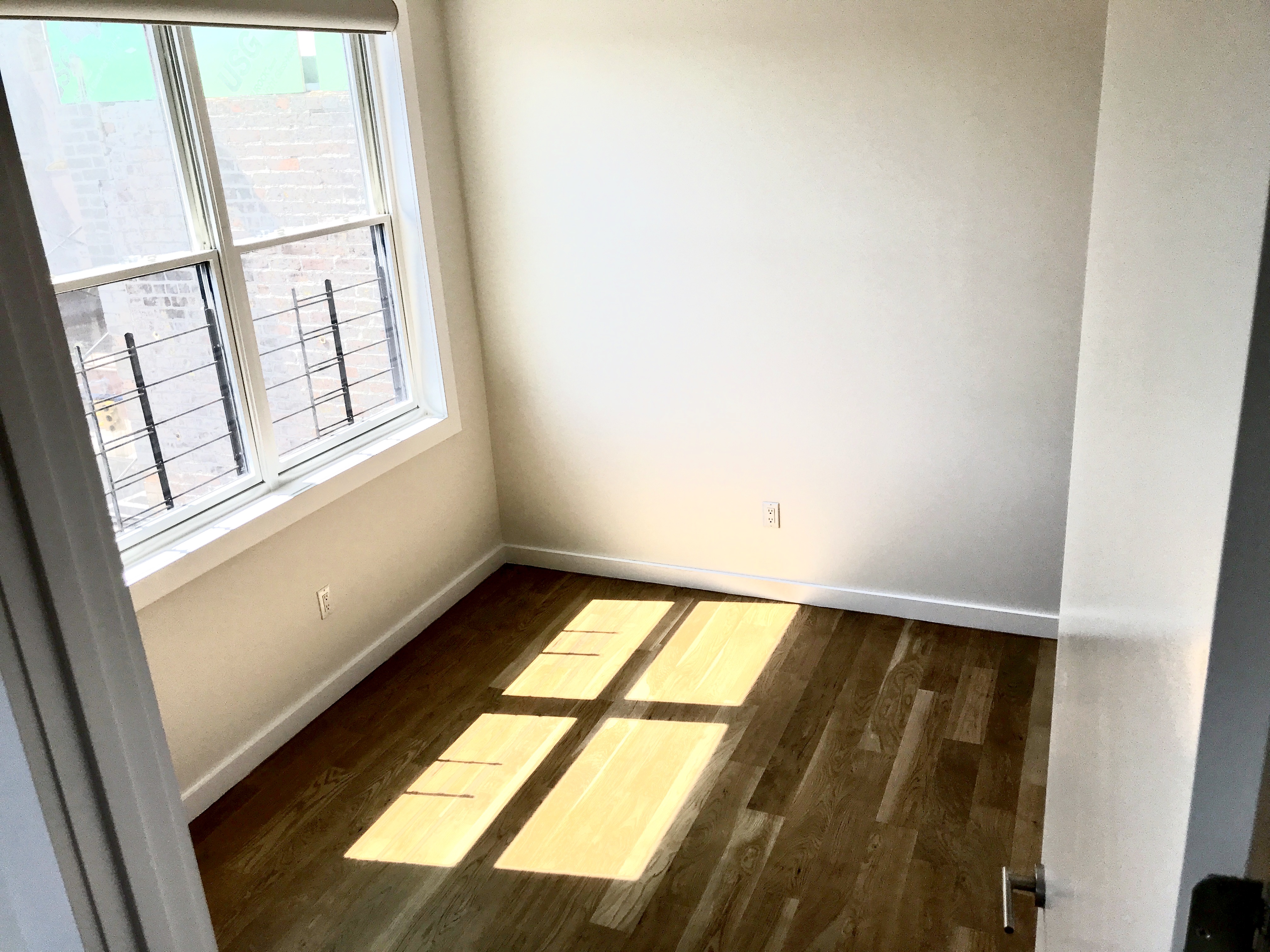 1149 Bedford Avenue, Unit 4A Brooklyn, NY 11216 - Photo 6 of 9 an empty room with windows