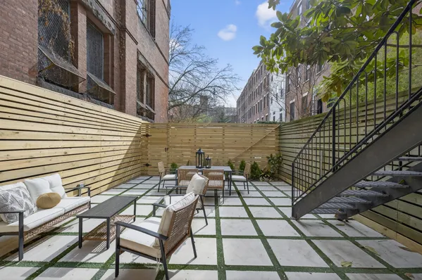 a view of a chairs and table in the balcony