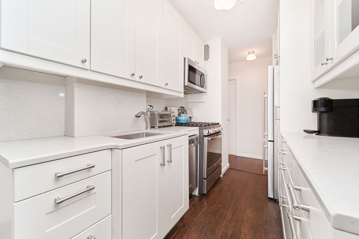 a kitchen with cabinets appliances and a counter space