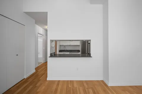 a room with wooden floor and a fireplace