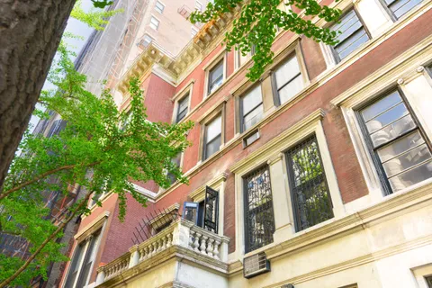 a view of an buildings with a tree