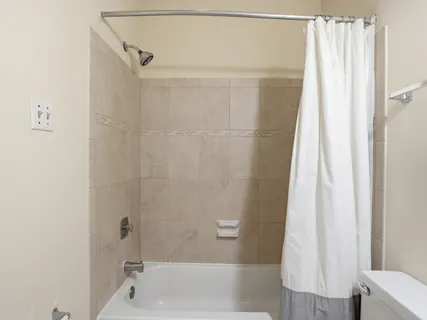 a bathroom with a shower and a tub