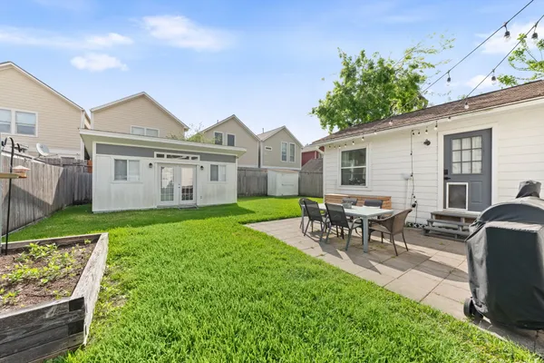 a front view of a house with backyard and porch