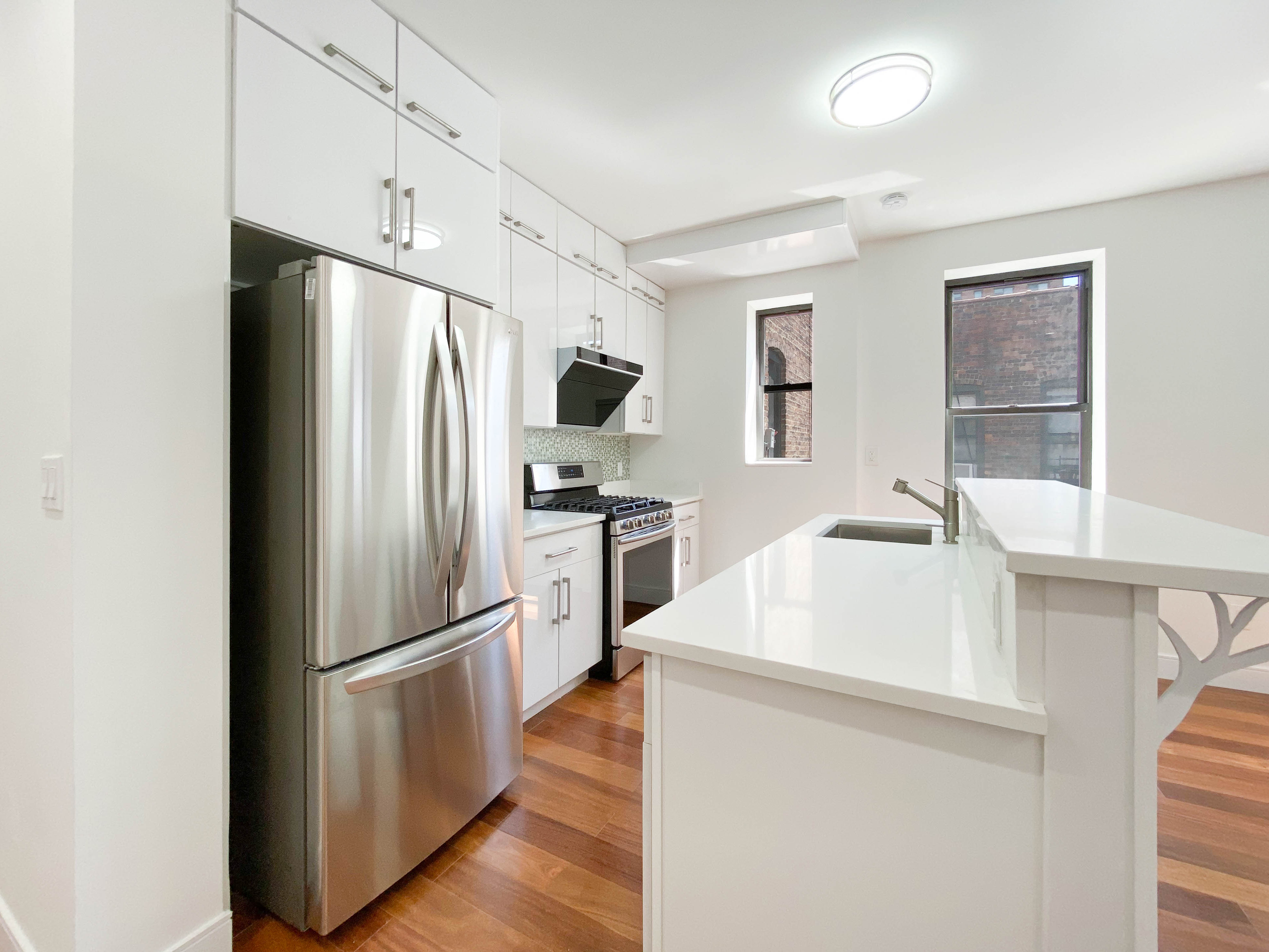 200 West 109th Street, Unit E4 Manhattan, NY 10025 - Photo 4 of 13 a kitchen with a refrigerator sink and wooden floor