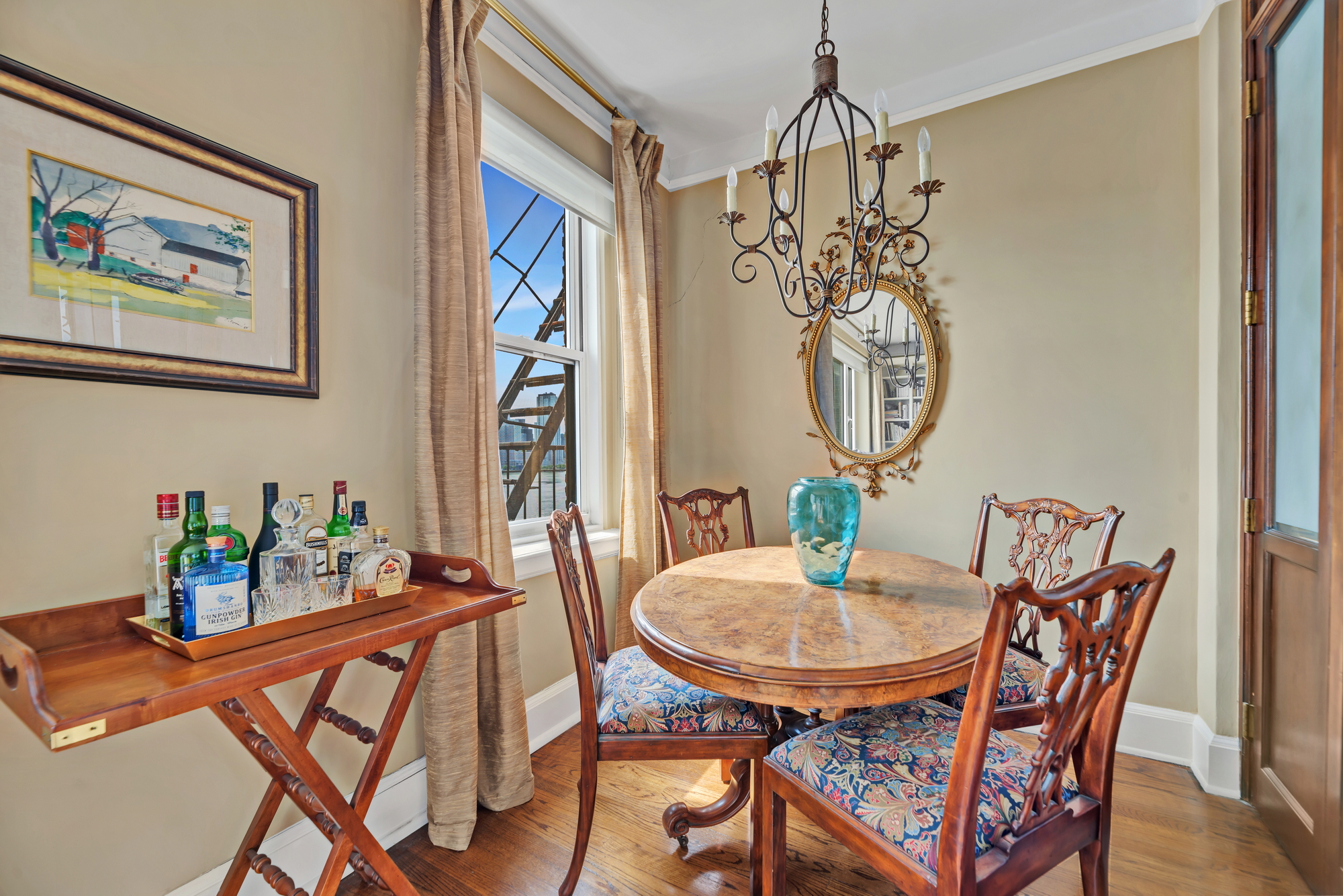 455 East 51st Street, Unit 6B Manhattan, NY 10022 - Photo 4 of 17 a view of a dining room with furniture a chandelier and a window