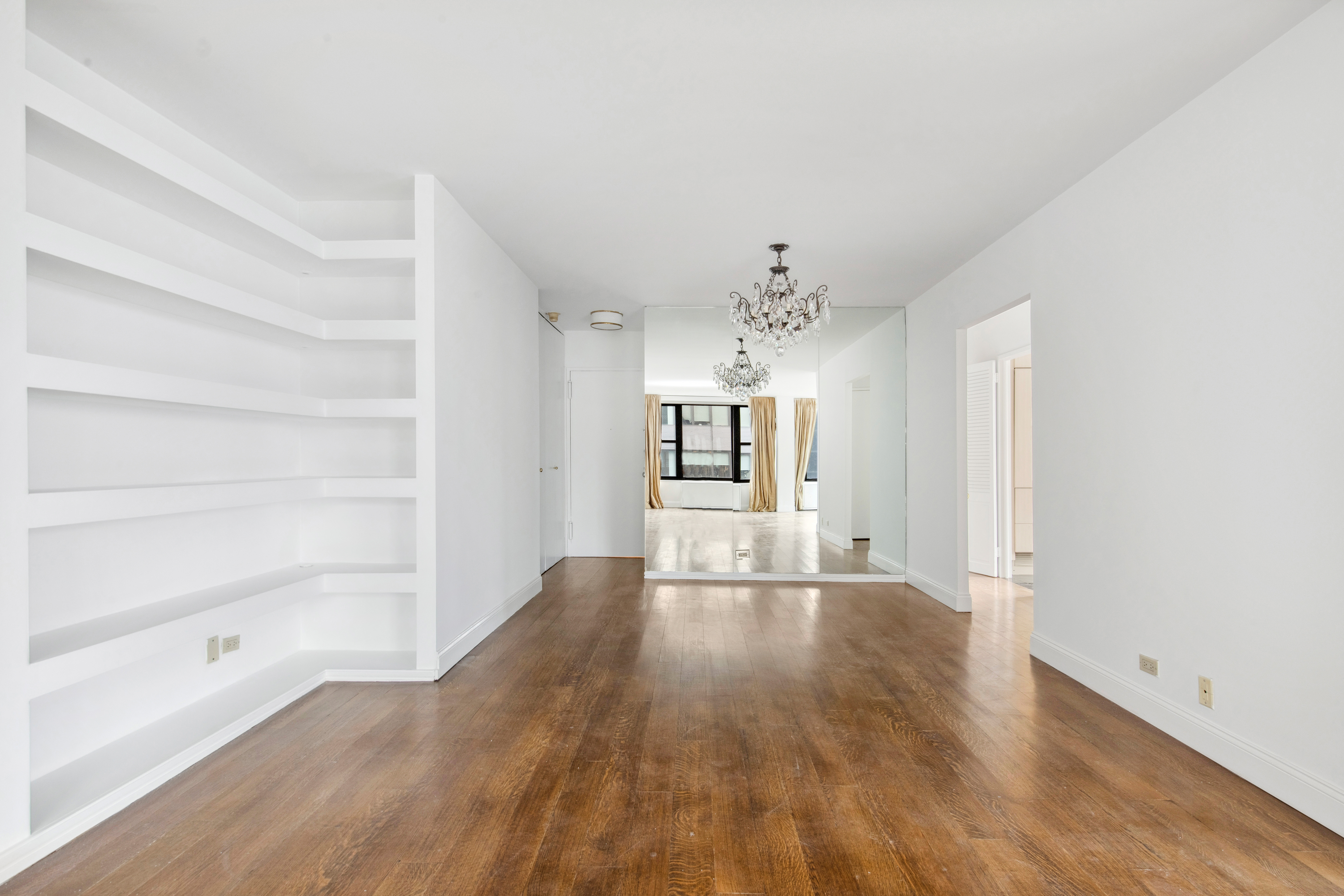 117 East 57th Street, Unit 35D Manhattan, NY 10022 - Photo 10 of 30 a view of a big room with wooden floor and windows