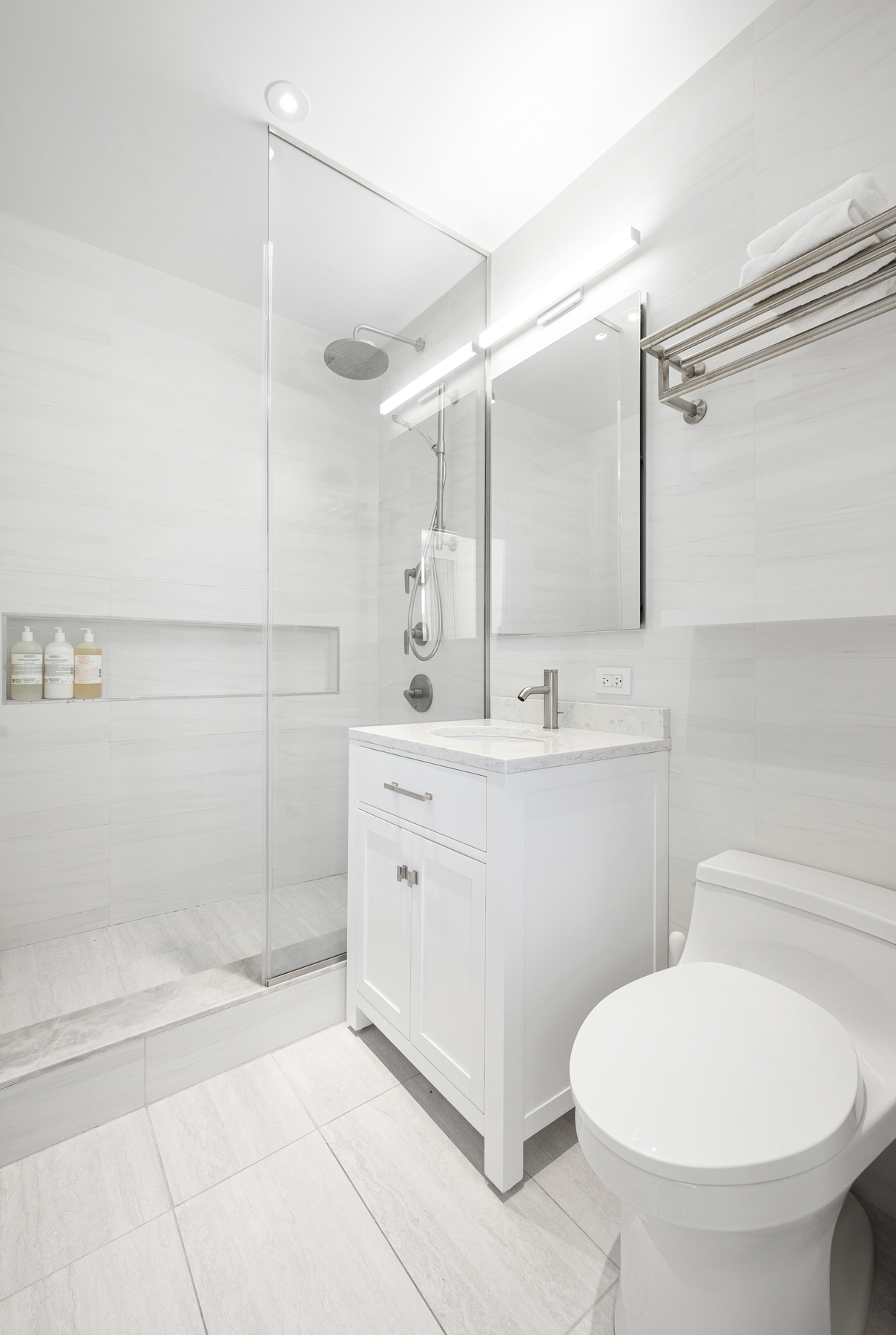 10 West End Avenue, Unit 30C Manhattan, NY 10023 - Photo 16 of 22 a bathroom with a sink a toilet and shower