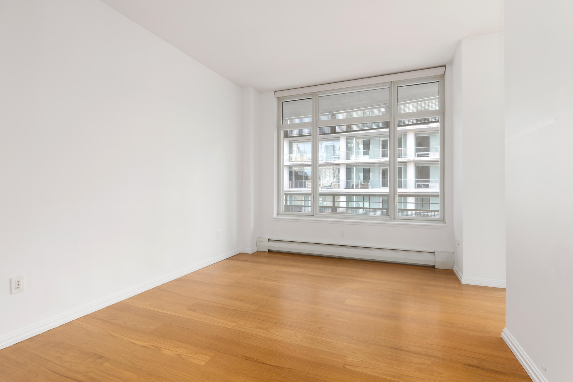 205 East 59th Street, Unit 10B Manhattan, NY 10022 - Photo 4 of 10 a view of an empty room with a window