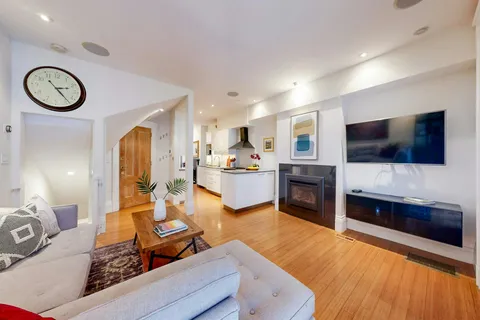 a living room with fireplace furniture and a flat screen tv