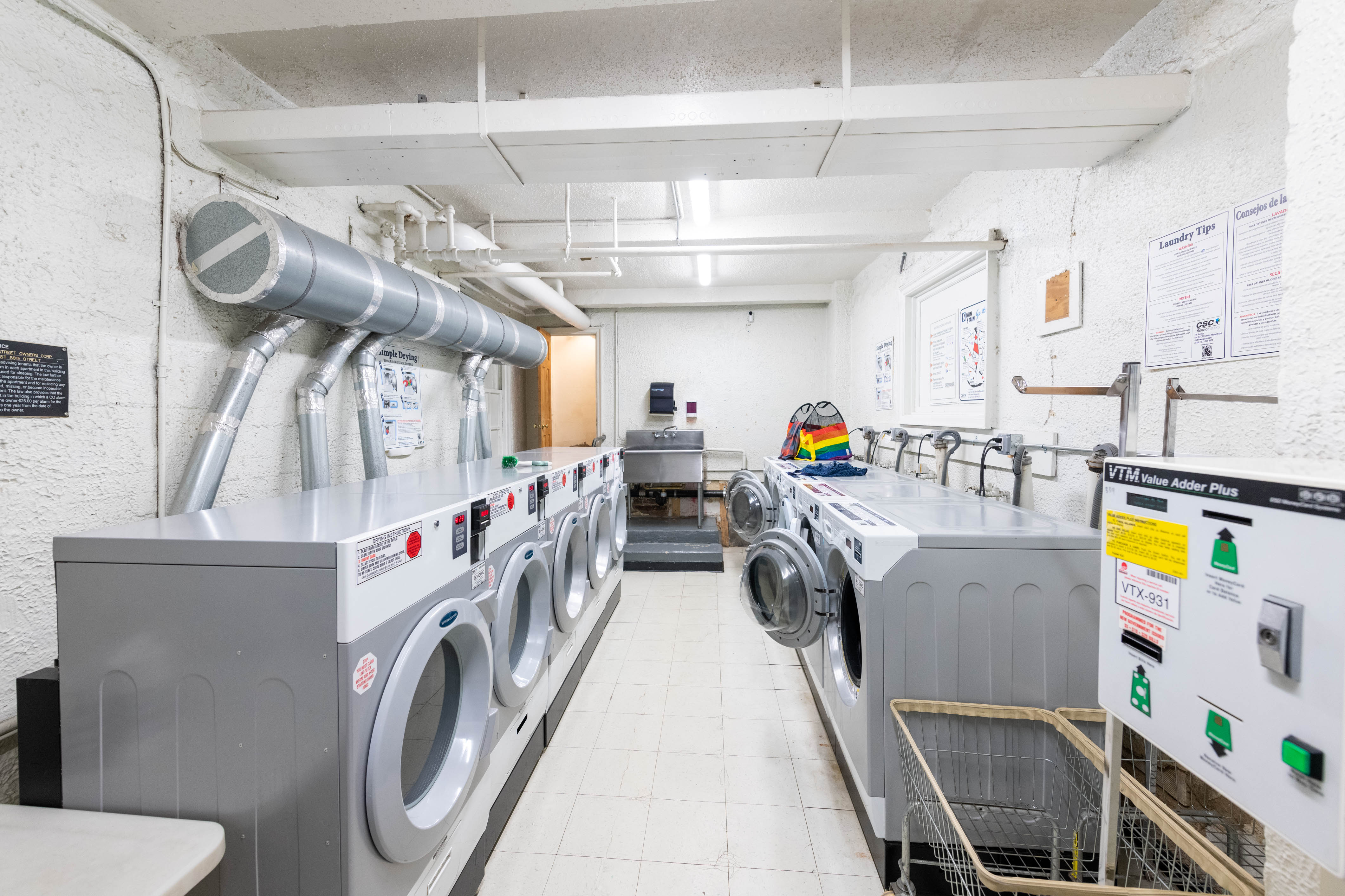 339 East 58th Street, Unit 5B Manhattan, NY 10022 - Photo 9 of 13 a utility room with multiple dryer and washer