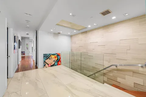 a view of a hallway with wooden floor