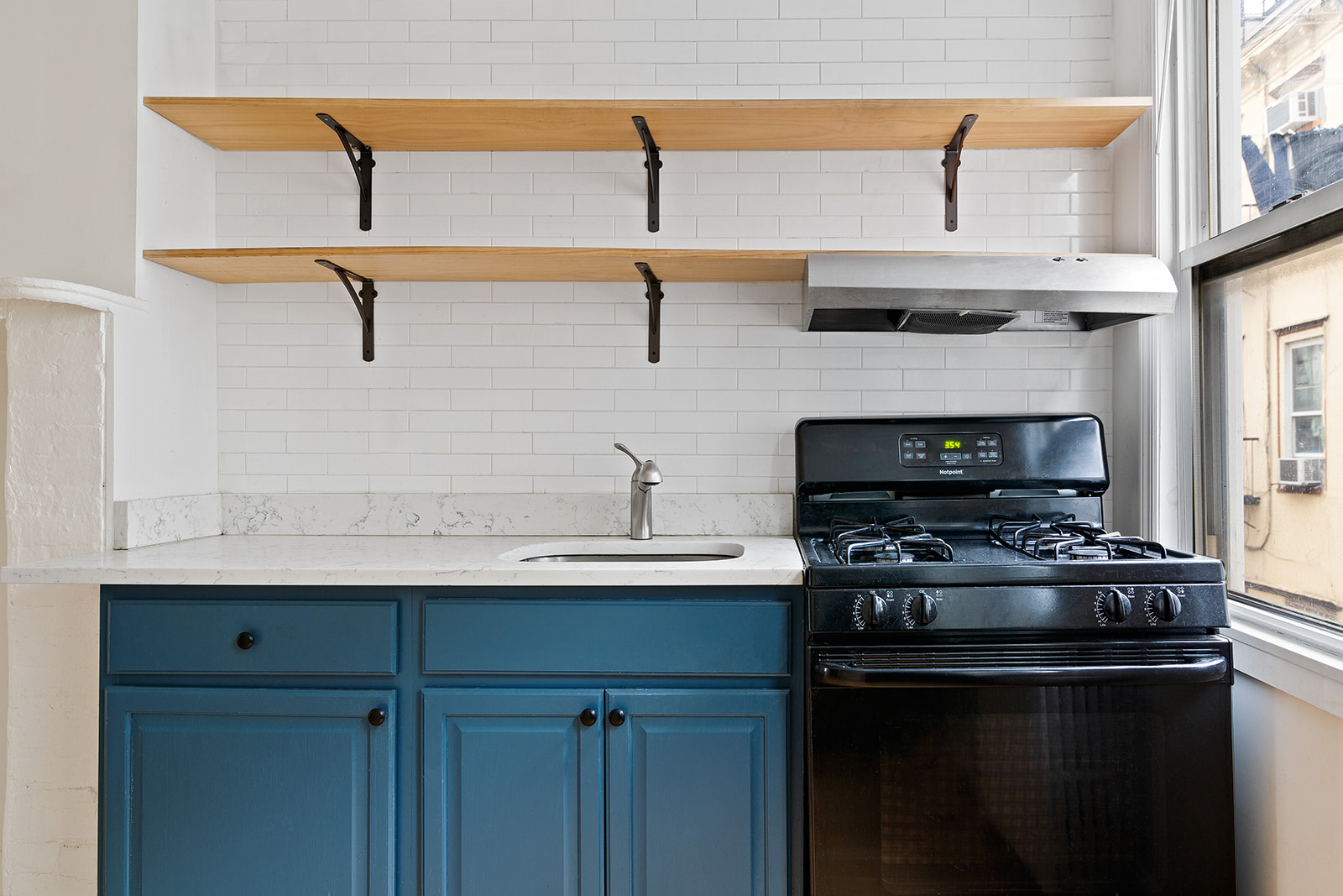 283 Devoe Street, Unit 2RR Brooklyn, NY 11211 - Photo 3 of 11 a kitchen with stainless steel appliances a stove and a sink