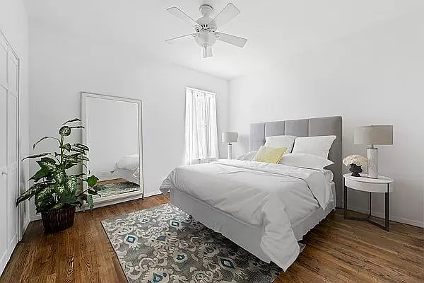 604 Riverside Drive, Unit 4E Manhattan, NY 10031 - Photo 2 of 8 a bedroom with bed and a potted plant