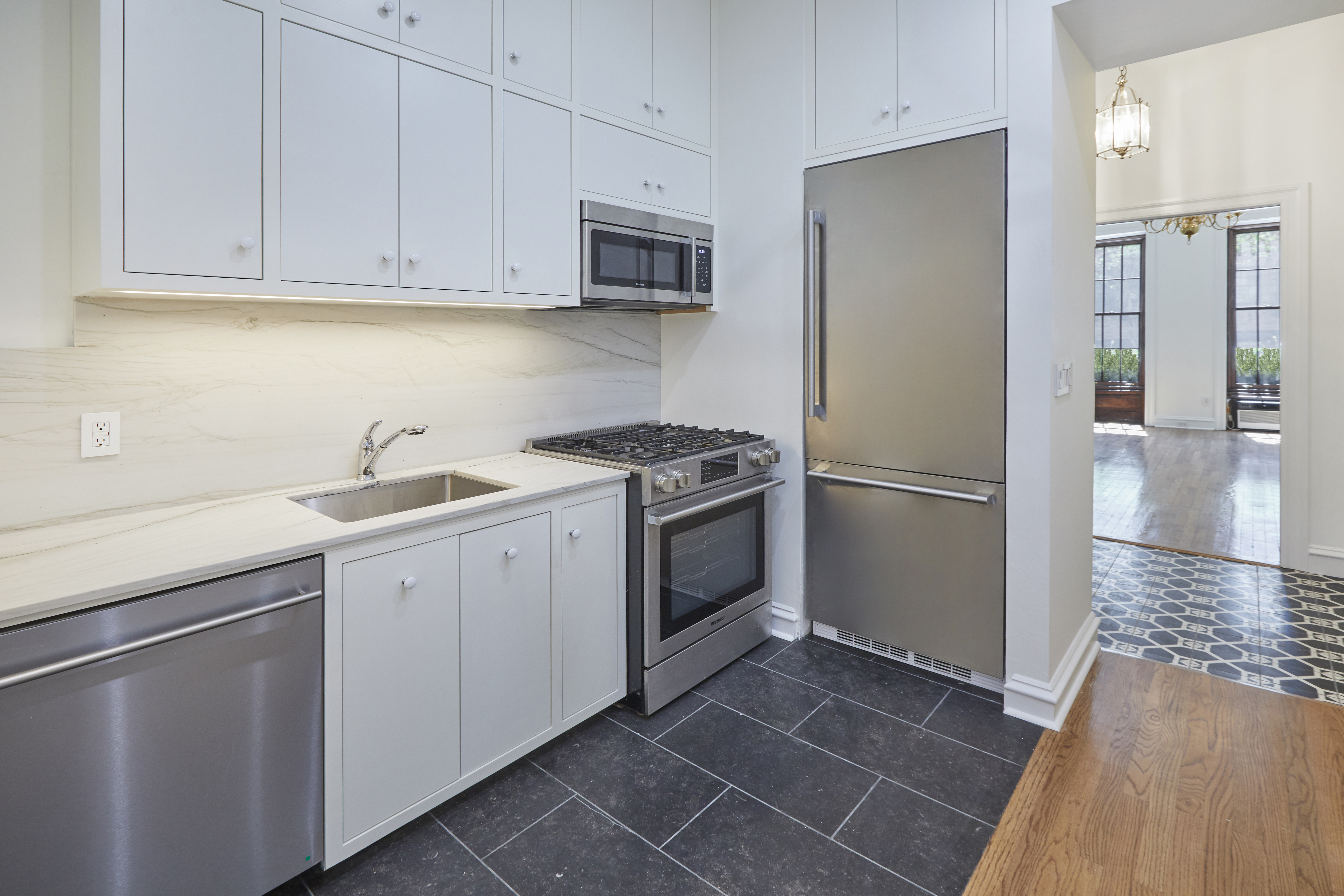 157 East 75th Street, Unit 1E Manhattan, NY 10021 - Photo 12 of 21 a kitchen with a sink appliances and cabinets