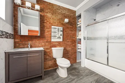 a bathroom with a toilet sink and a shower