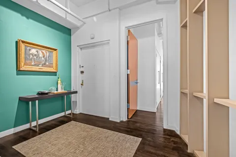 a view of a workspace with furniture and wooden floor