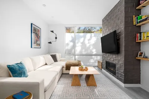 a living room with furniture fireplace and a flat screen tv