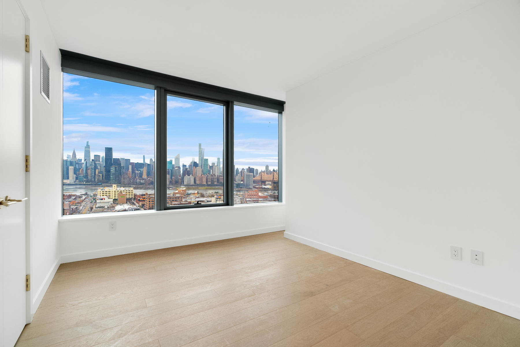 3 Court Square, Unit 2911 Queens, NY 11101 - Photo 9 of 22 a view of an empty room with a window