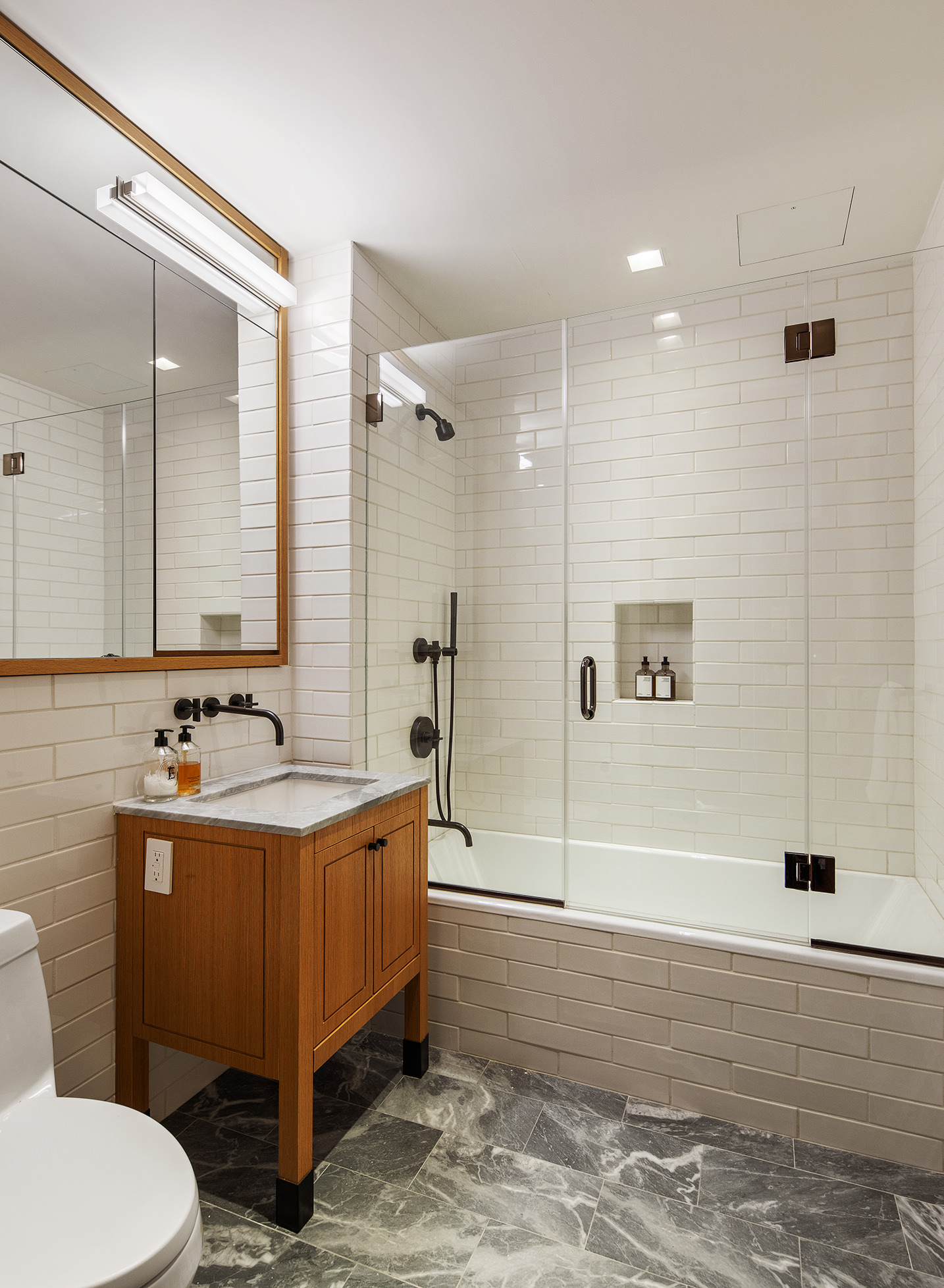 36 Bleecker Street, Unit 3DC Manhattan, NY 10012 - Photo 27 of 30 a bathroom with a sink mirror toilet and bathtub
