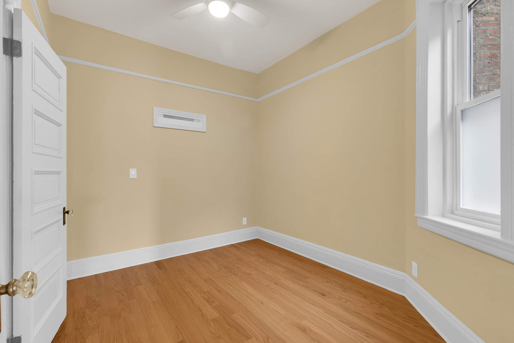 159 Prospect Park West, Unit 4 Brooklyn, NY 11215 - Photo 6 of 14 a view of an empty room with wooden floor and a window