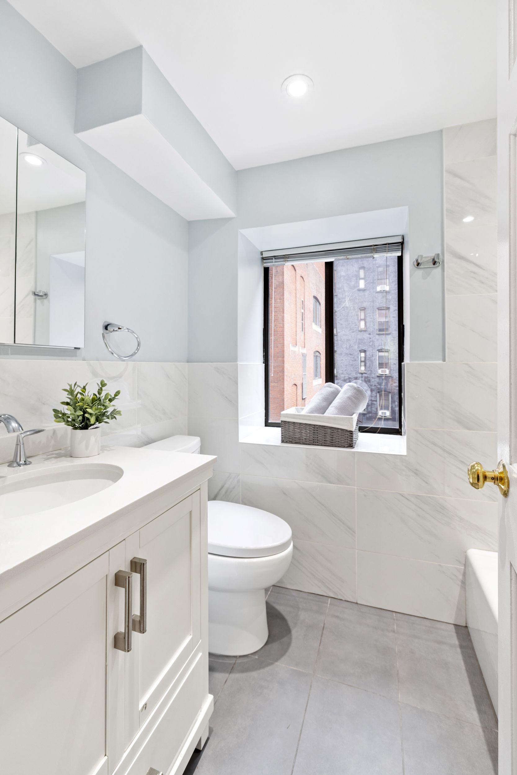 248 East 31st Street, Unit 4A Manhattan, NY 10016 - Photo 8 of 14 a bathroom with a sink toilet and window