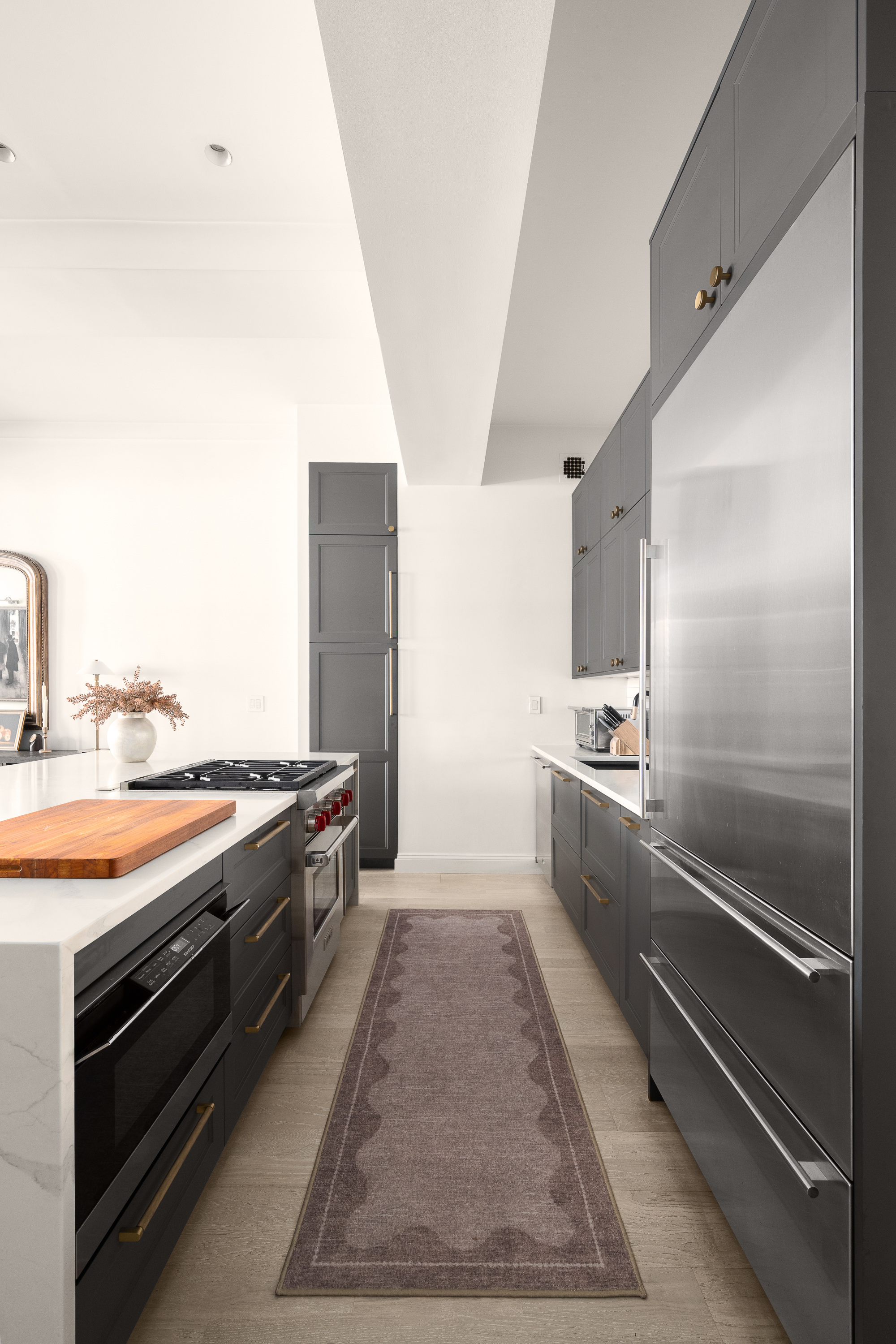 521 West 47th Street, Unit 3B Manhattan, NY 10036 - Photo 7 of 15 a large kitchen with kitchen island granite countertop a stove and a refrigerator