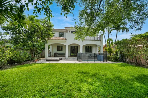 a view of a house with a yard and sitting area