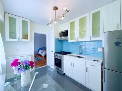 a kitchen with a sink cabinets and window