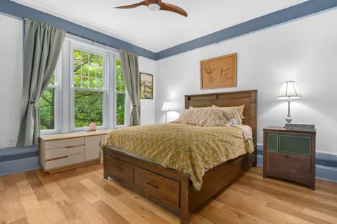 a bed sitting in a bedroom next to a window
