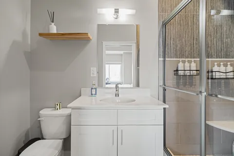 a bathroom with a sink toilet and shower