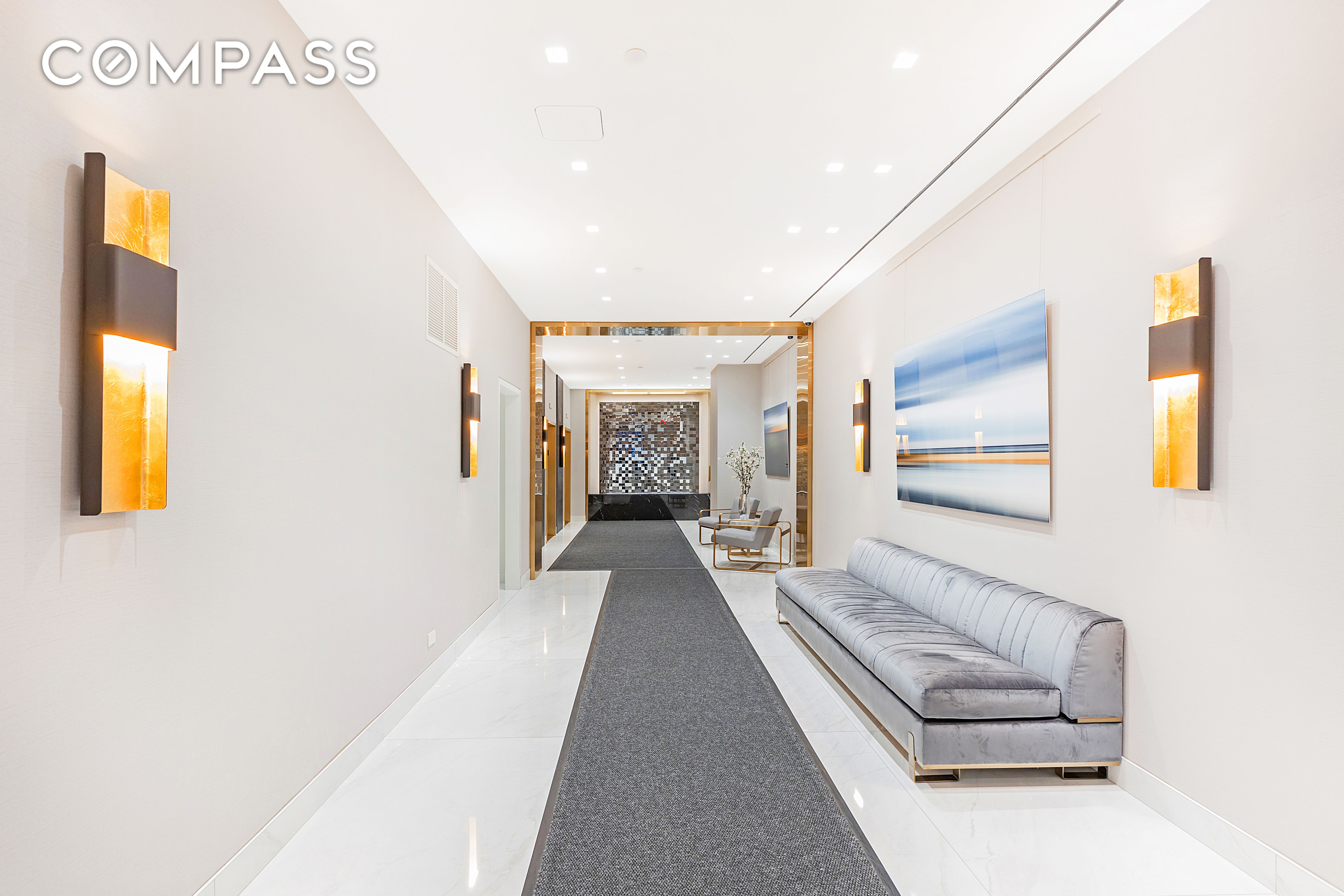 150 West 51st Street, Unit 1909 Manhattan, NY 10019 - Photo 11 of 12 a hallway with a couches and a flat screen tv