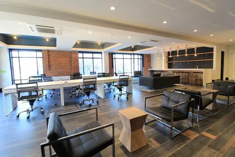 a living room with furniture a wooden floor and a window