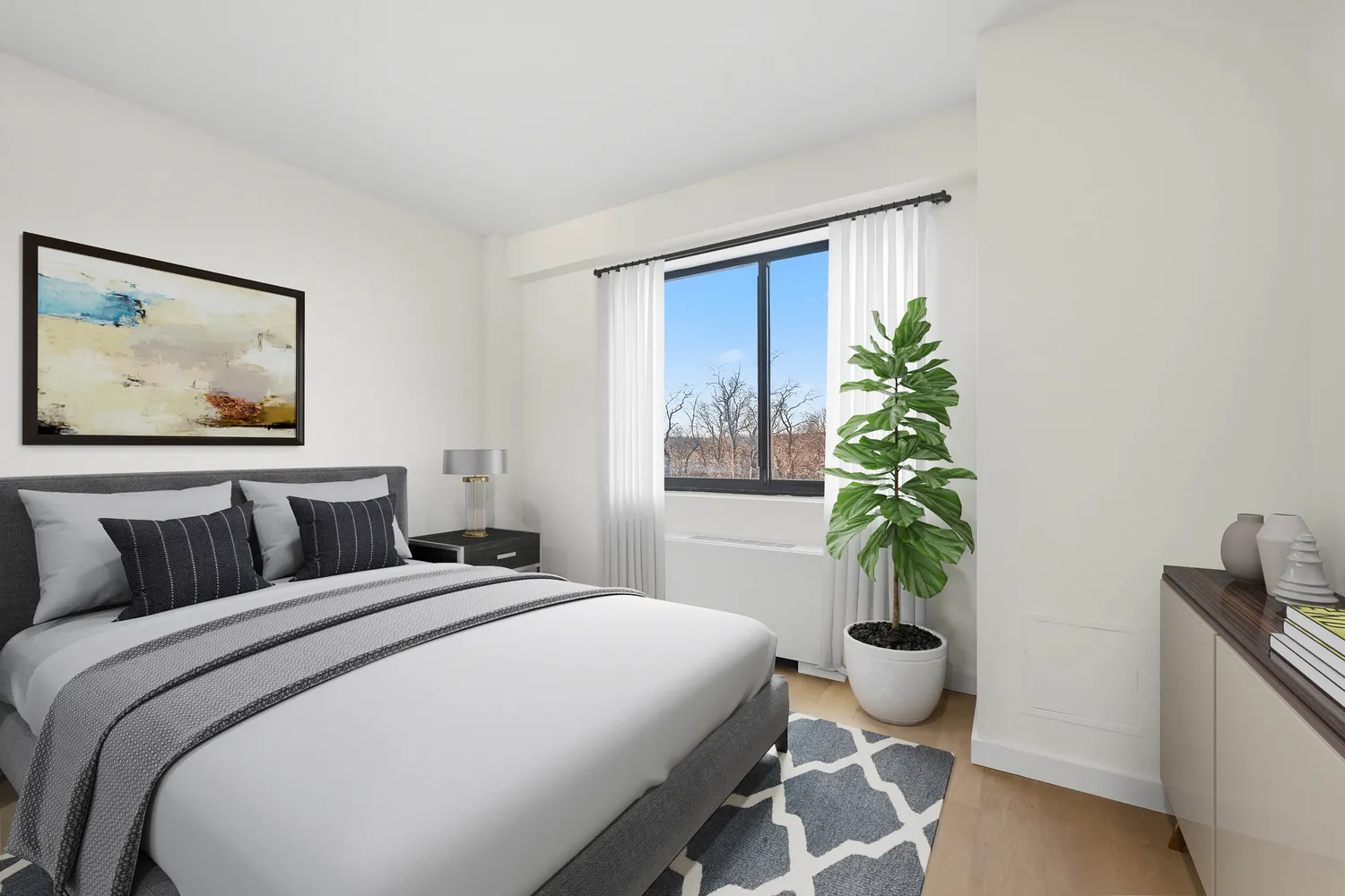a bedroom with a large bed and a potted plant