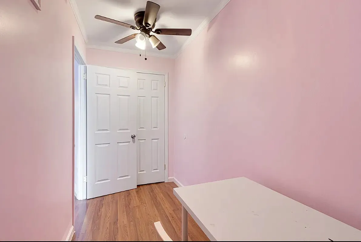 a view of empty room with a fan
