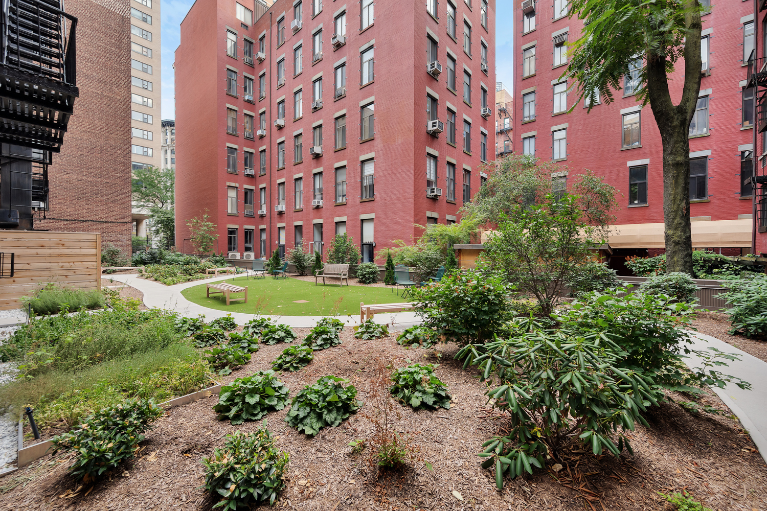 a view of a building with garden and trees