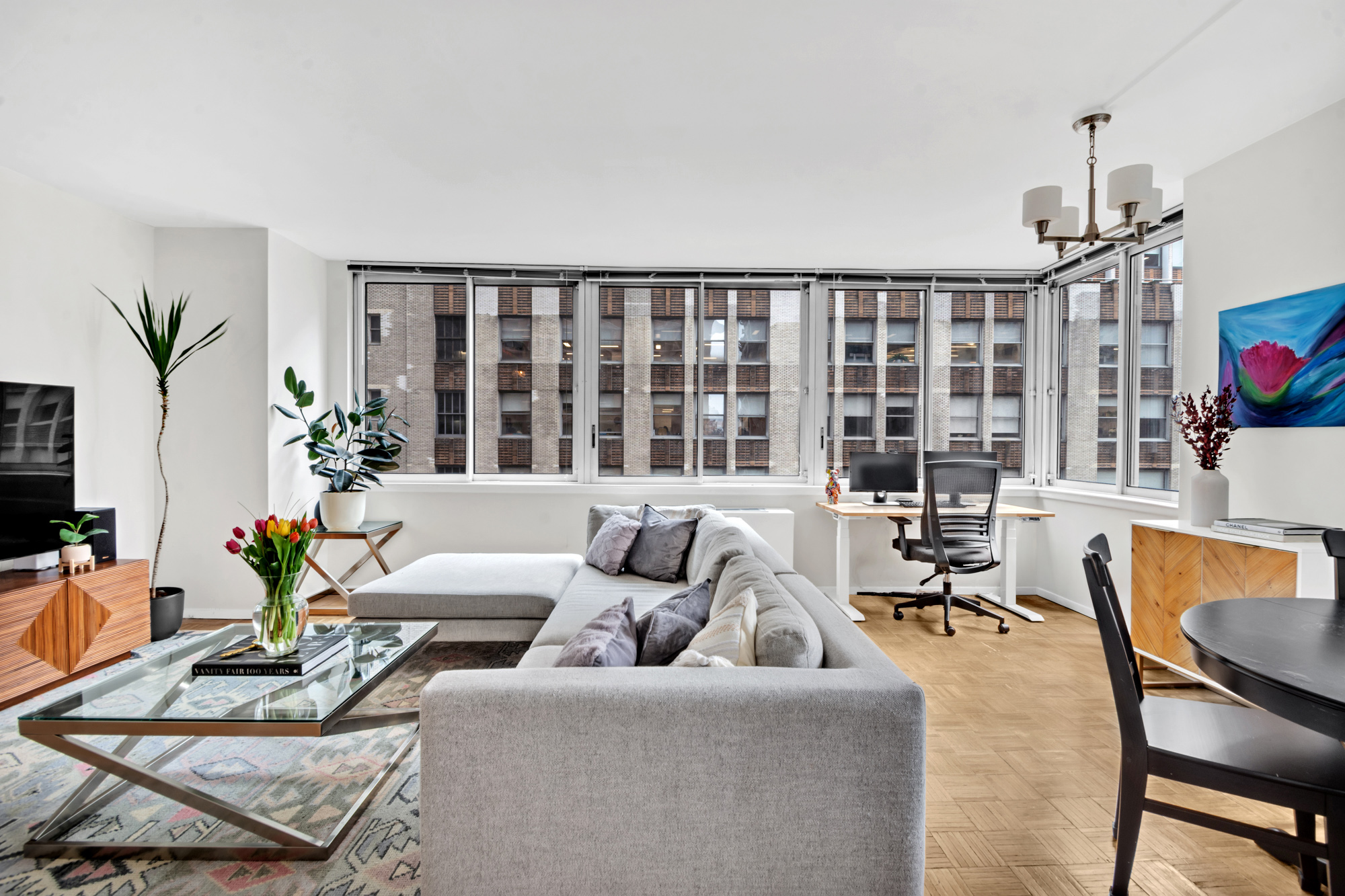 235 East 40th Street, Unit 11G Manhattan, NY 10016 - Photo 2 of 20 a living room with furniture and a floor to ceiling window